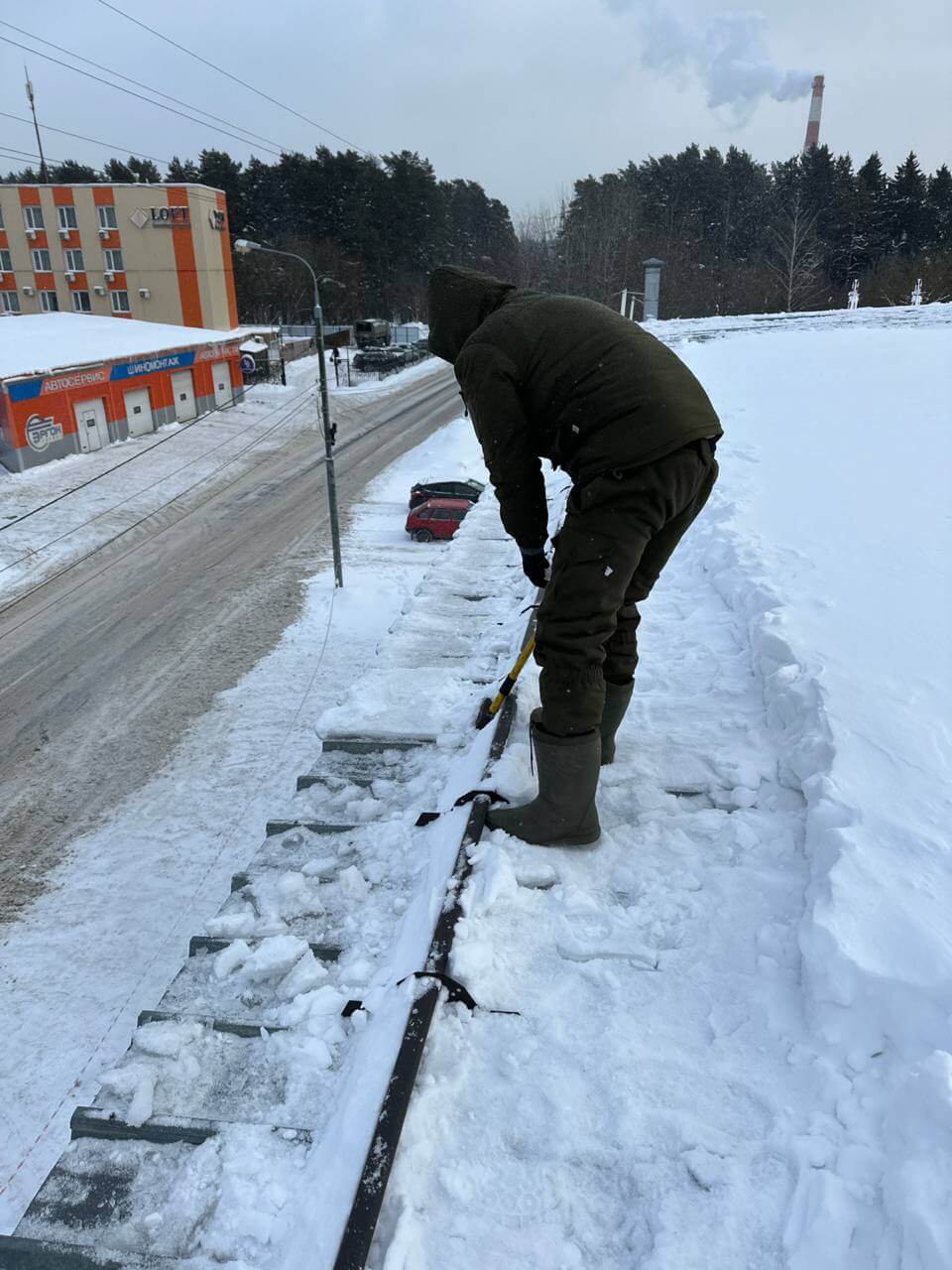 Уборка снега и наледи на кровле здания в Первомайском